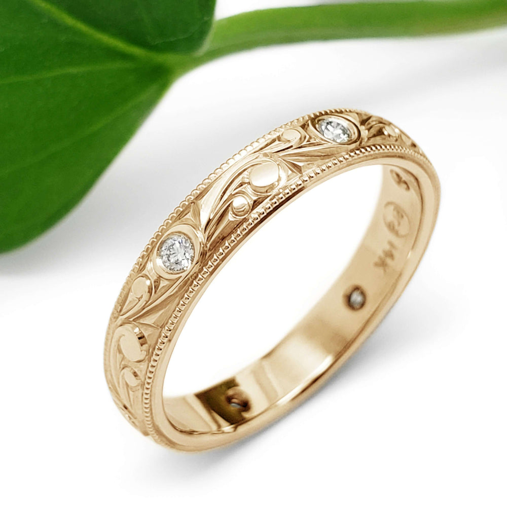Engraved 14k yellow gold wedding band with flush-set diamonds, leaf background