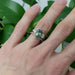 Engraved 14kt white gold chevron wedding ring stacked with gemstone and diamond ring on hand