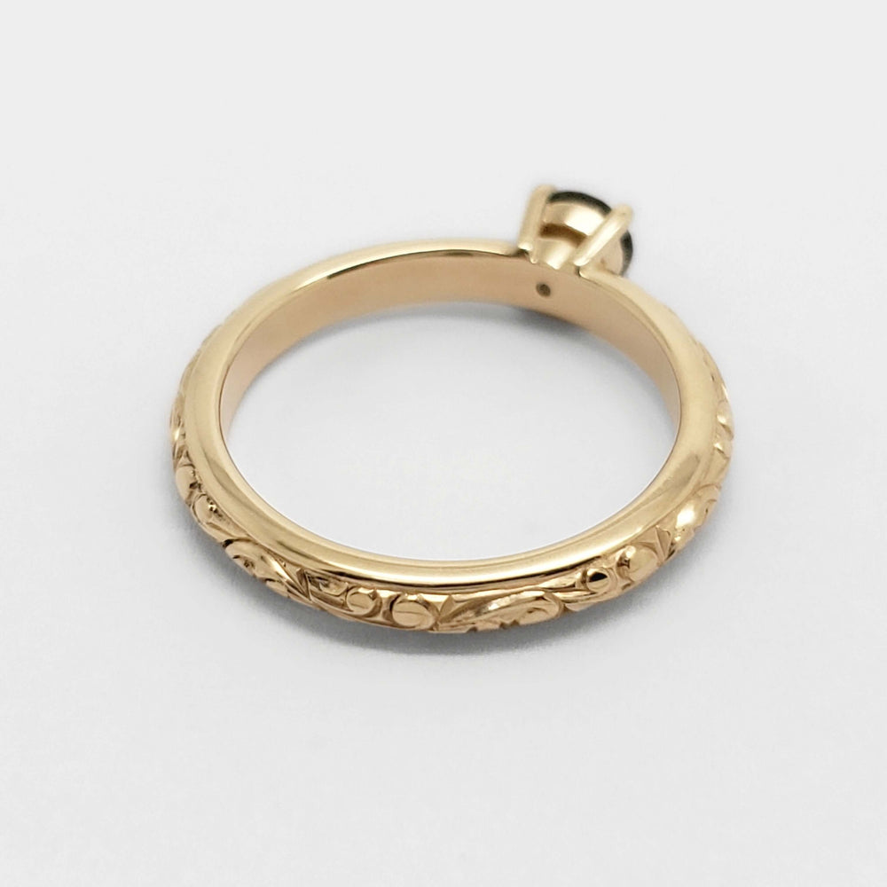 Engraved 14kt yellow gold band of Montana sapphire engagement ring, shown from above
