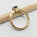 Side view of engraved 14kt yellow gold ring with teal Australian sapphire, showing detailed hand engraving