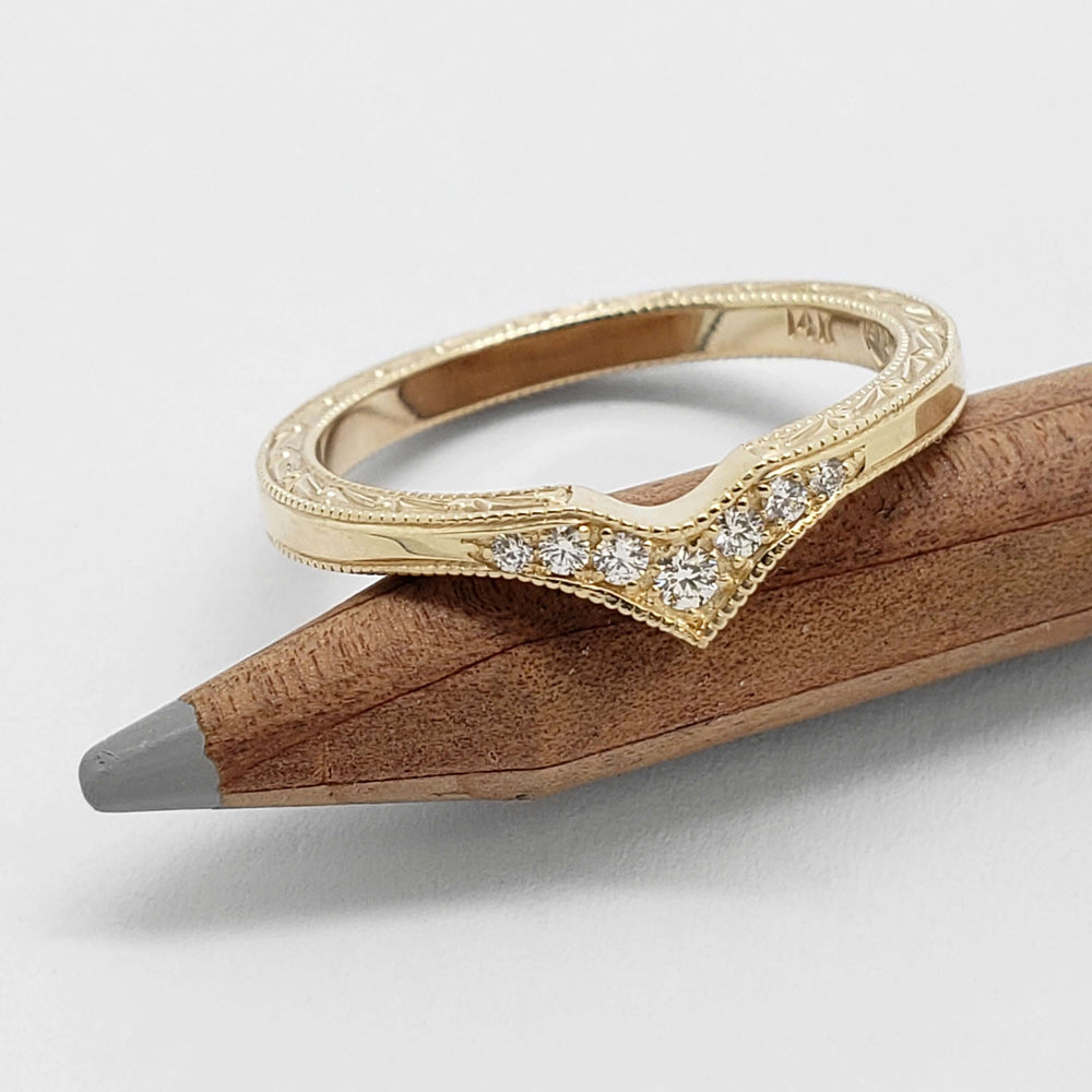Engraved 14k yellow gold chevron wedding ring with pave-set Canadian diamonds on a pencil