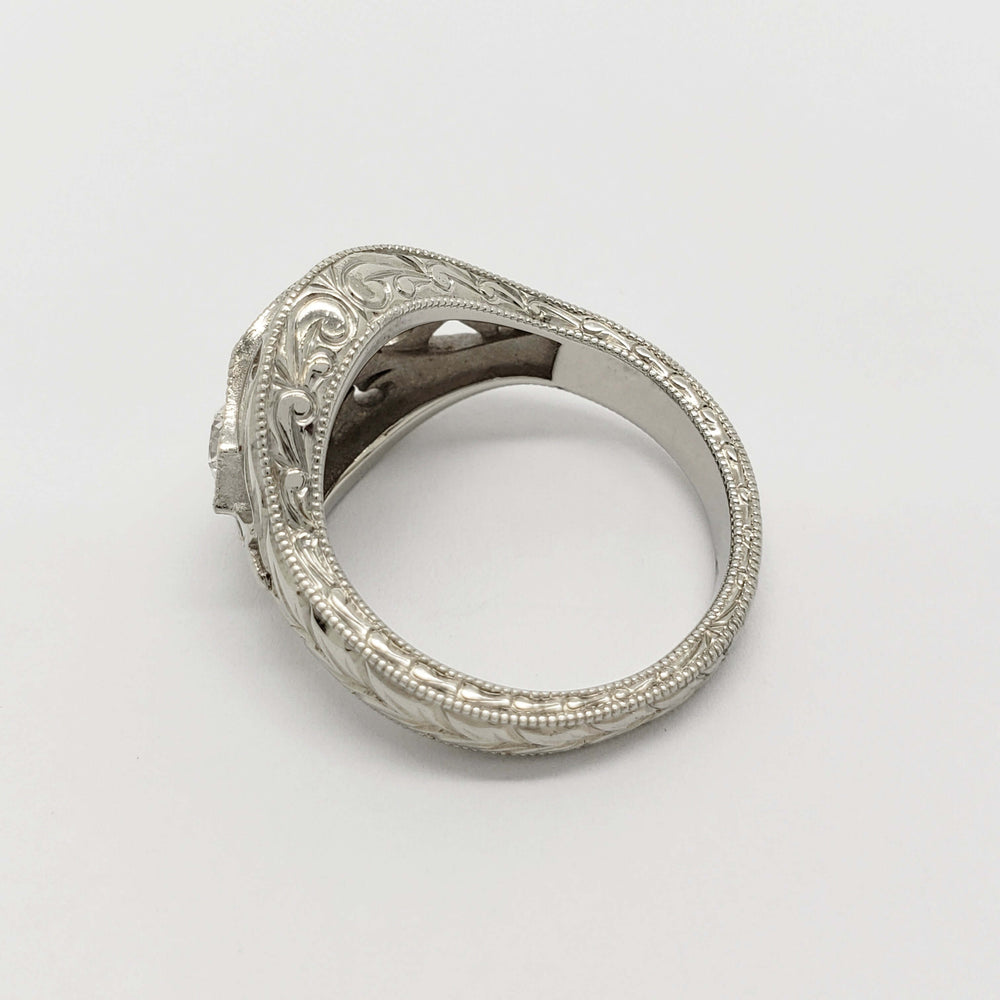 Detailed engraving on the band of a white gold Montana sapphire and diamond ring