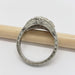 Detailed engraving on the band of a 14kt white gold ring with blue sapphires and lab diamond
