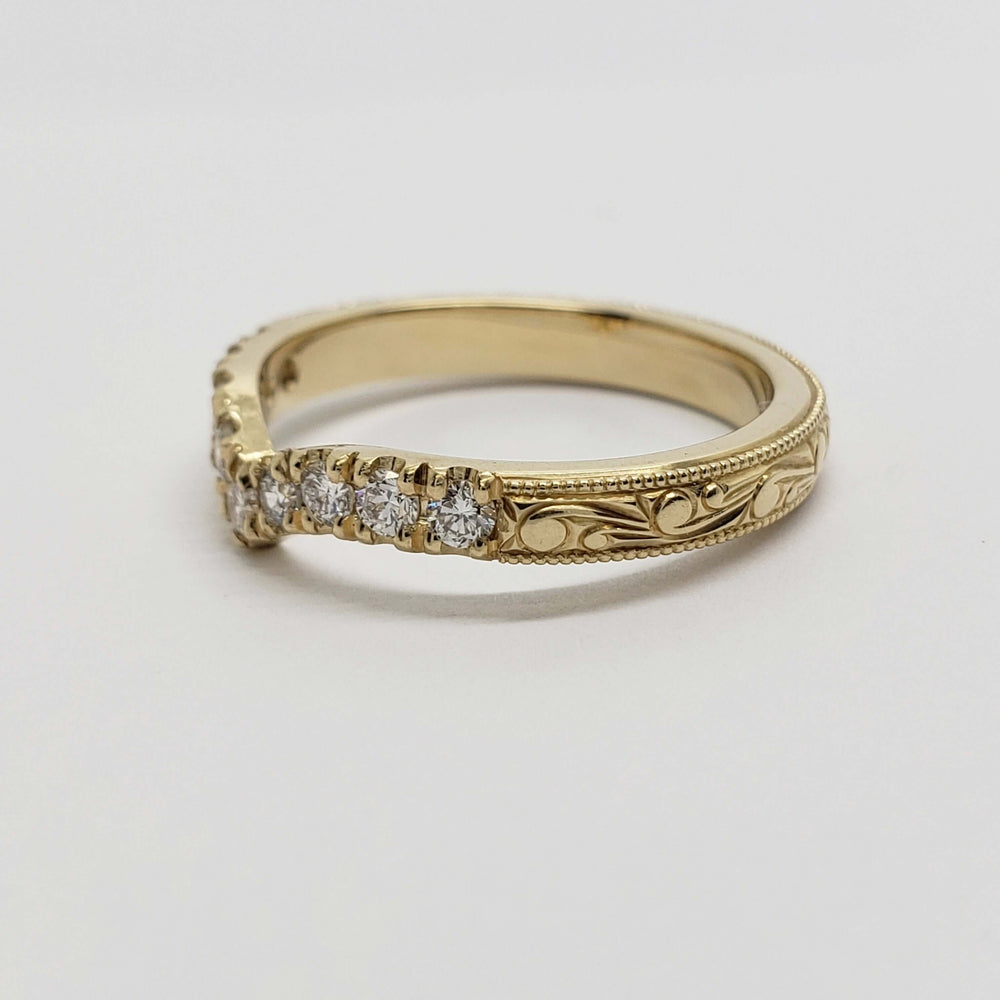 Side view of engraved 14kt yellow gold and lab diamond chevron wedding ring