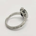 Side view of engraved white gold ring with detailed under-gallery and milgrain edges
