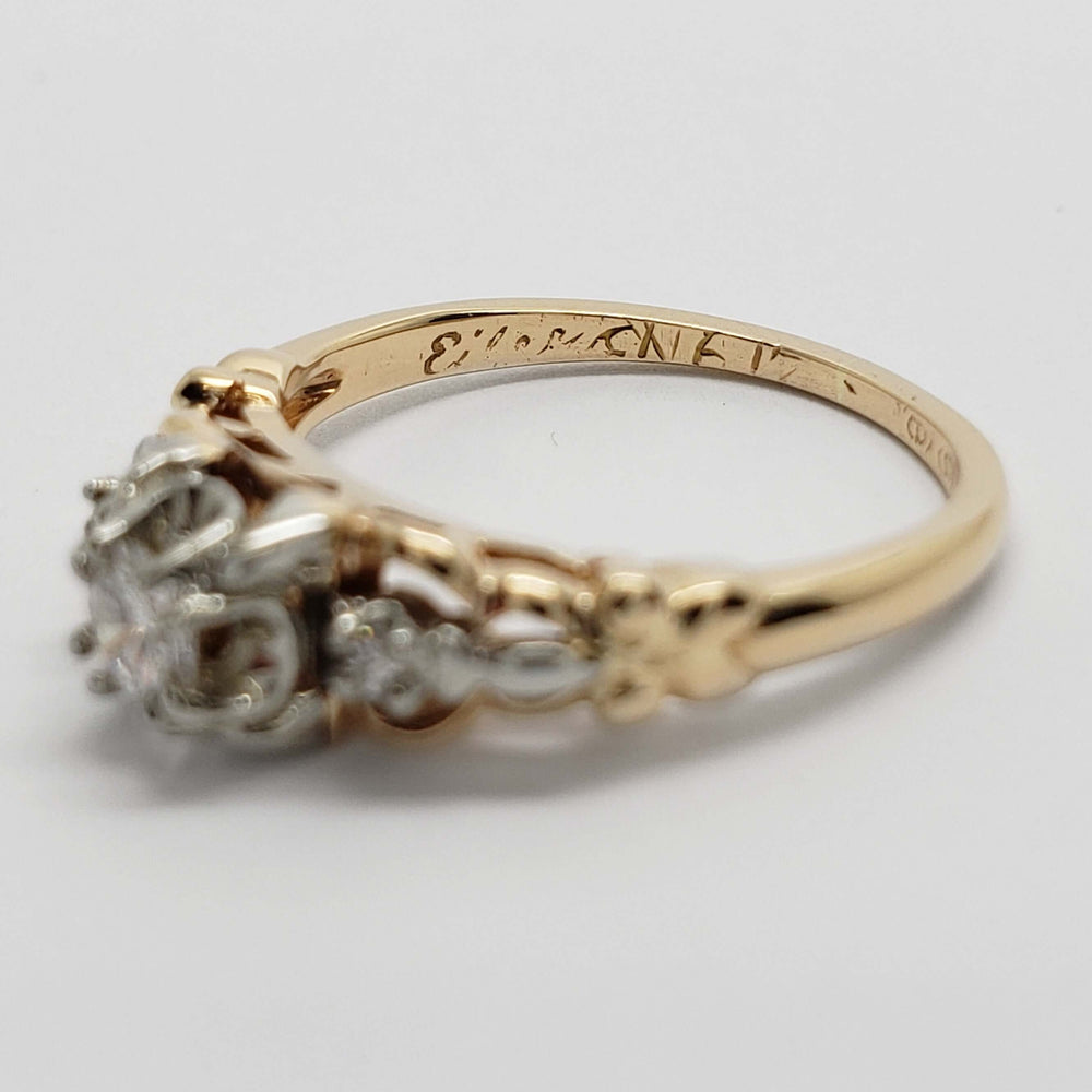 Close-up of inside band engraving on vintage yellow and white gold diamond ring