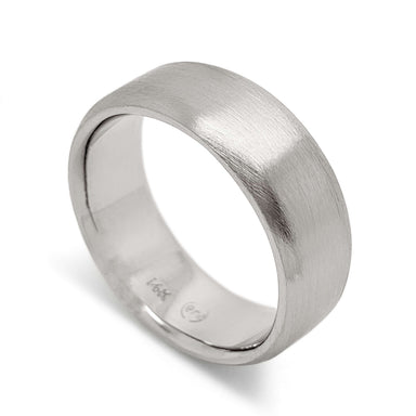 Flat 14kt white gold wedding band with brushed finish, angled view
