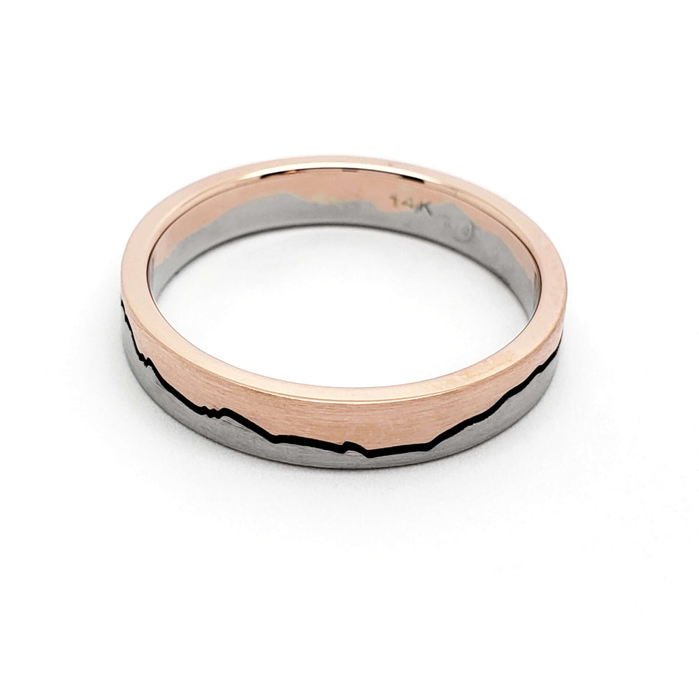Flat profile 14k white and rose gold mountain range wedding band on white background