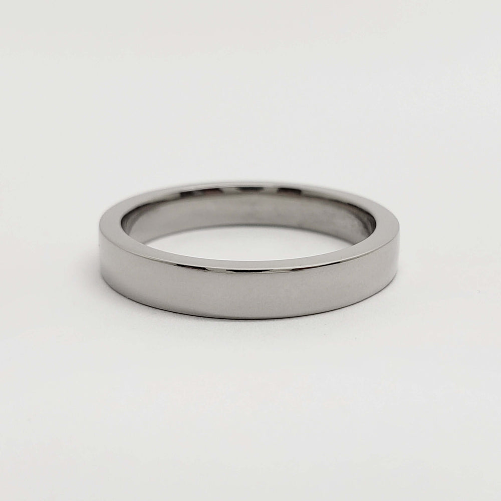 Flat profile 14kt palladium white gold wedding band on white background