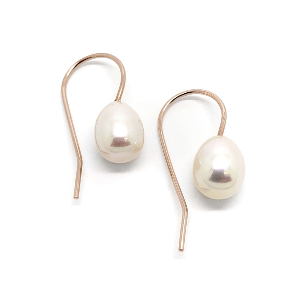 Pair of freshwater pearl drop earrings with rose 14kt gold hooks on white background