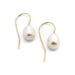 Pair of freshwater pearl drop earrings with yellow 14kt gold hooks on white background