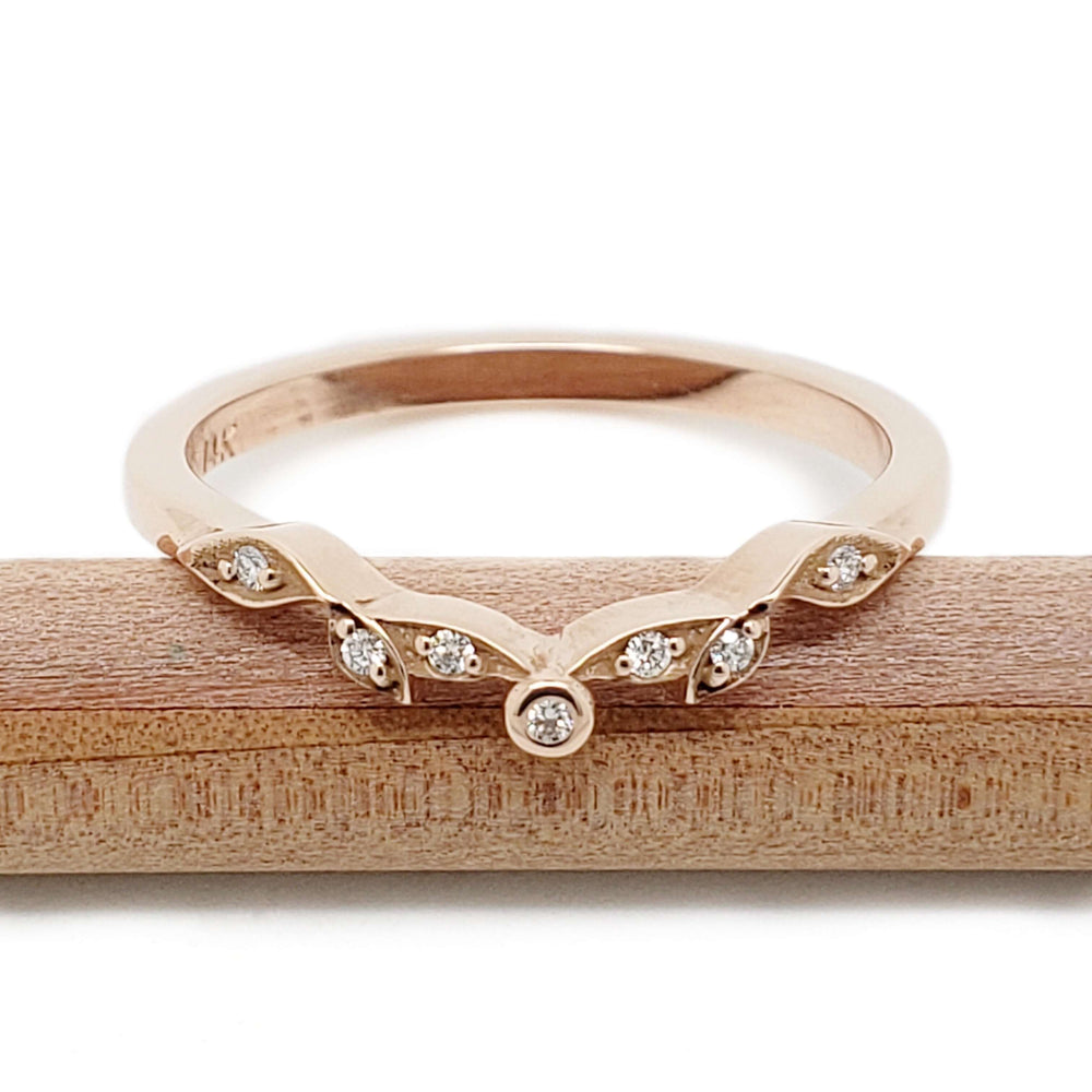 Front view of 14k rose gold wedding ring with bezel and pave-set Canadian diamonds