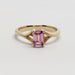 Front view of 14k yellow gold ring with emerald cut pink sapphire