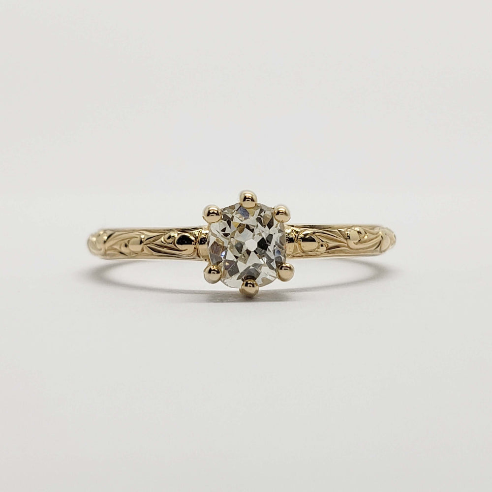 Front view of 14k yellow gold ring featuring an old mine cut diamond and engraved details