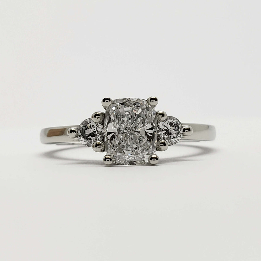 Front view of 14kt white gold engagement ring with cushion cut lab diamond and two round diamonds