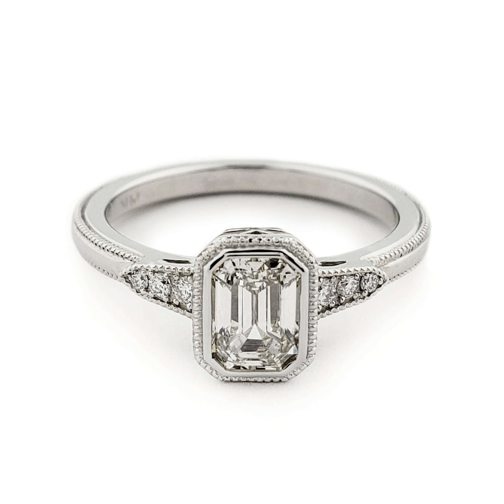 Front view of 14kt white gold engagement ring with emerald cut lab diamond and side stones