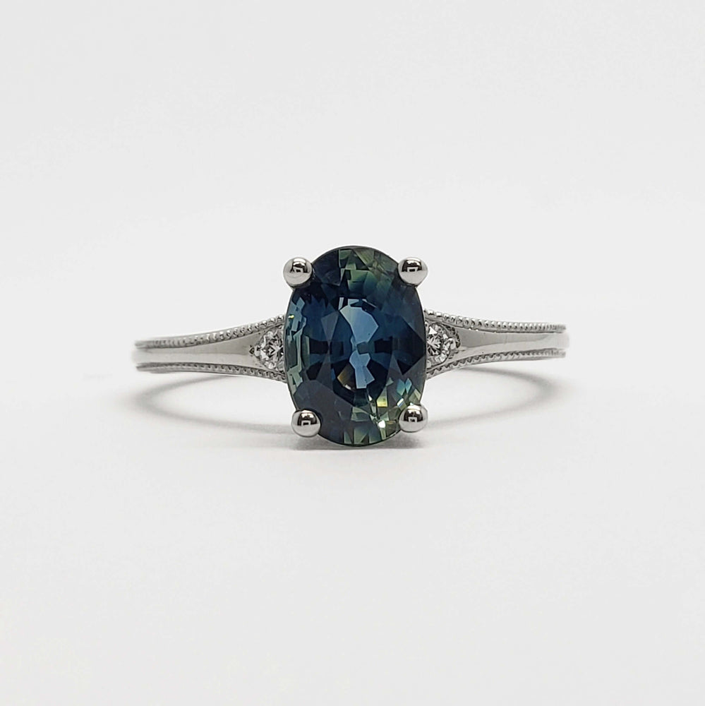 Front view of 14kt white gold ring with oval blue-green Australian sapphire and diamond accents
