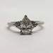 Front view of 14kt white gold ring with pear cut lab diamond and round diamond accents