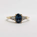 Front view of 14kt yellow gold ring with oval blue sapphire and two pear lab diamonds