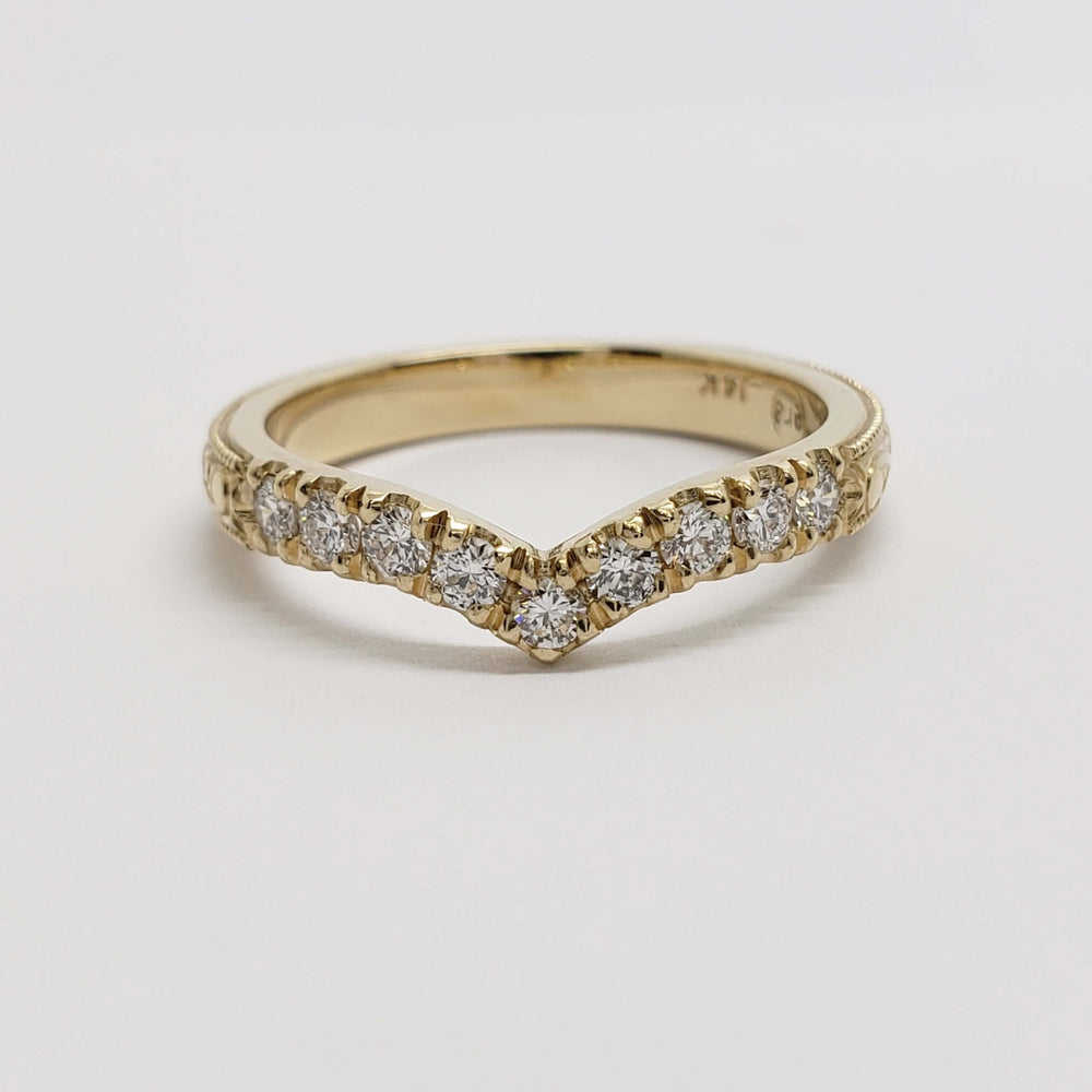 Front view of 14kt yellow gold chevron wedding ring featuring round lab diamonds