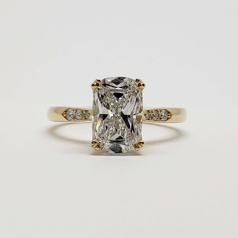 Front view of 14kt yellow gold engagement ring with cushion cut lab diamond and diamond accents