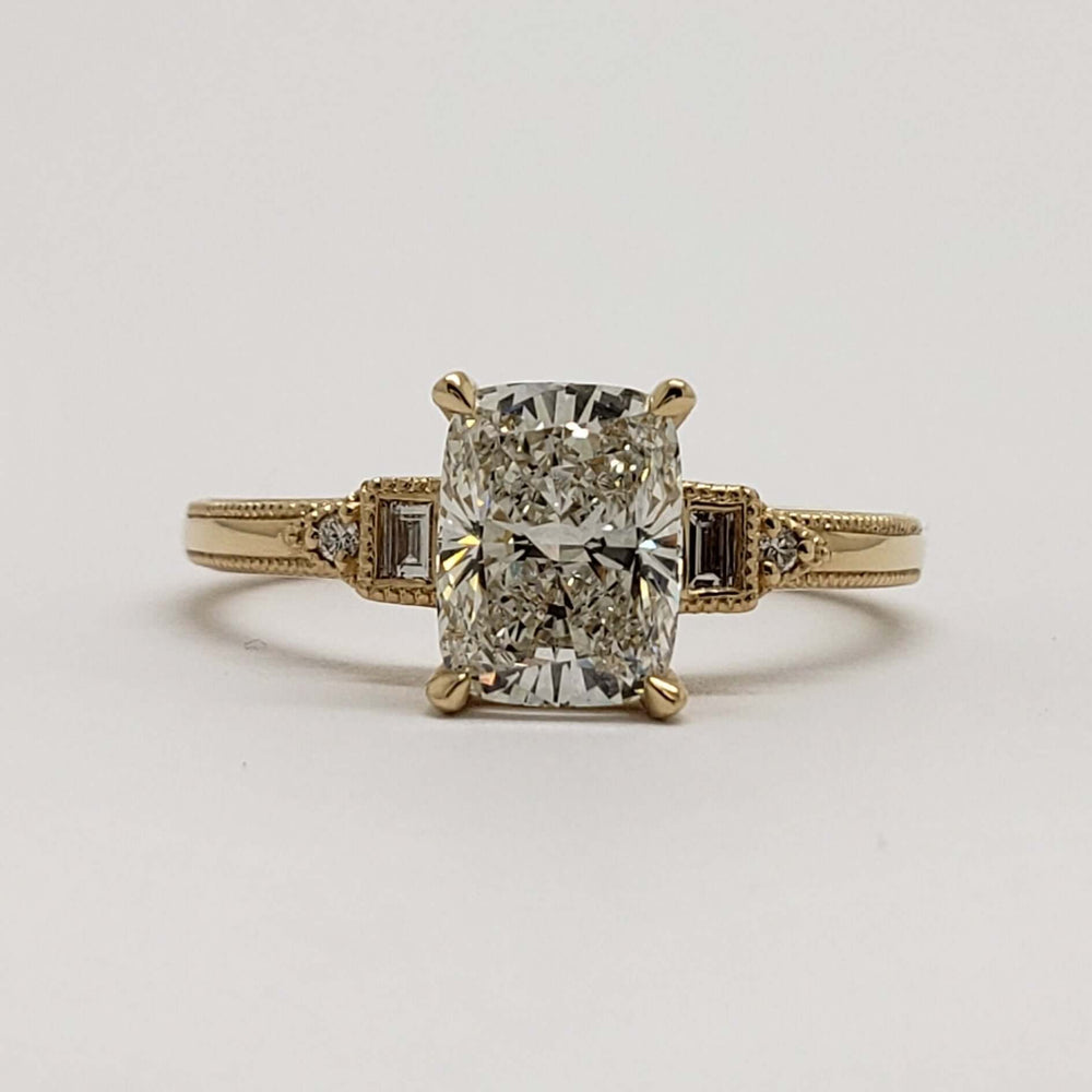 Front view of 14kt yellow gold engagement ring with cushion cut lab diamond and side stones