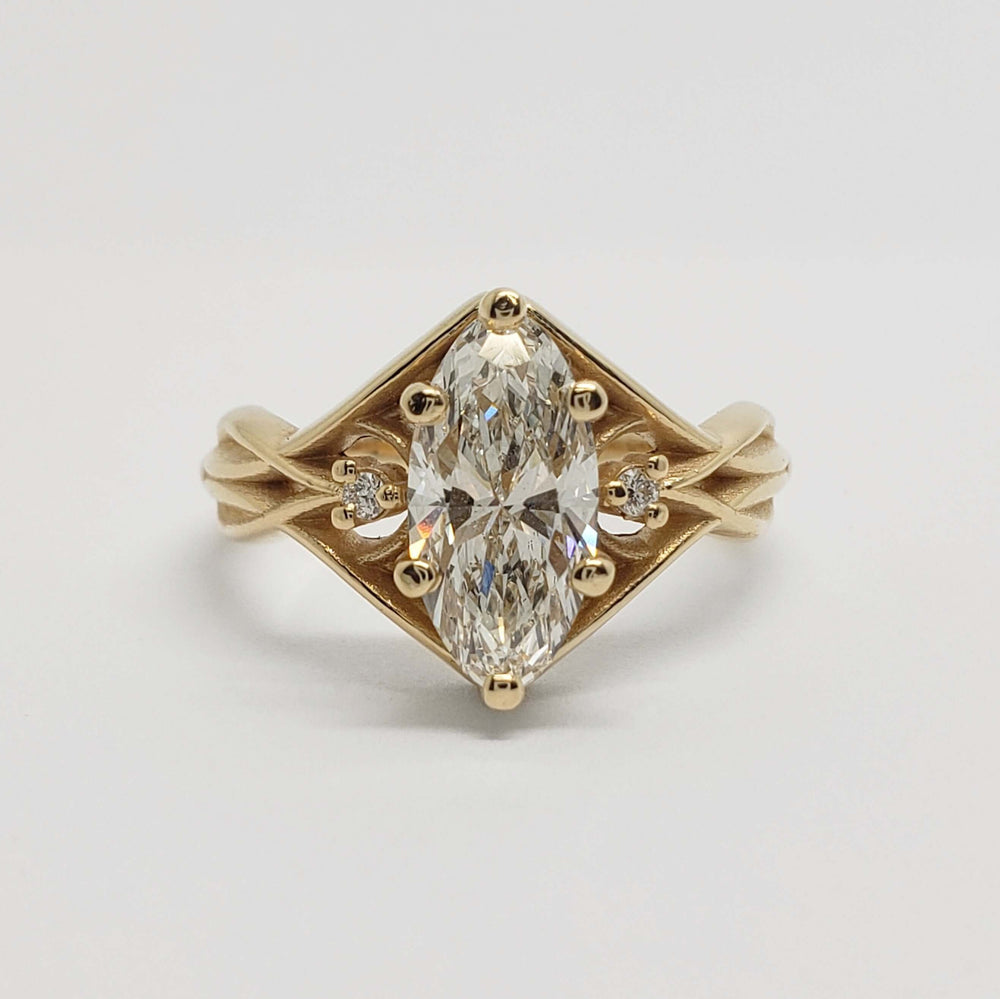 Front view of 14kt yellow gold engagement ring with marquise-oval lab diamond and accent stones