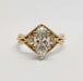 Front view of 14kt yellow gold engagement ring with marquise-oval lab diamond and accent stones