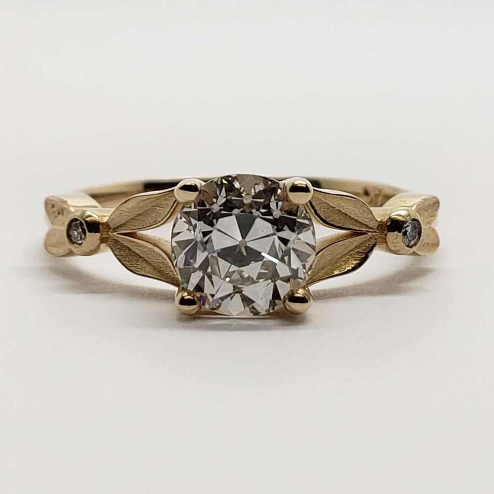 Front view of 14kt yellow gold engagement ring with old European cut lab diamond and leaf details