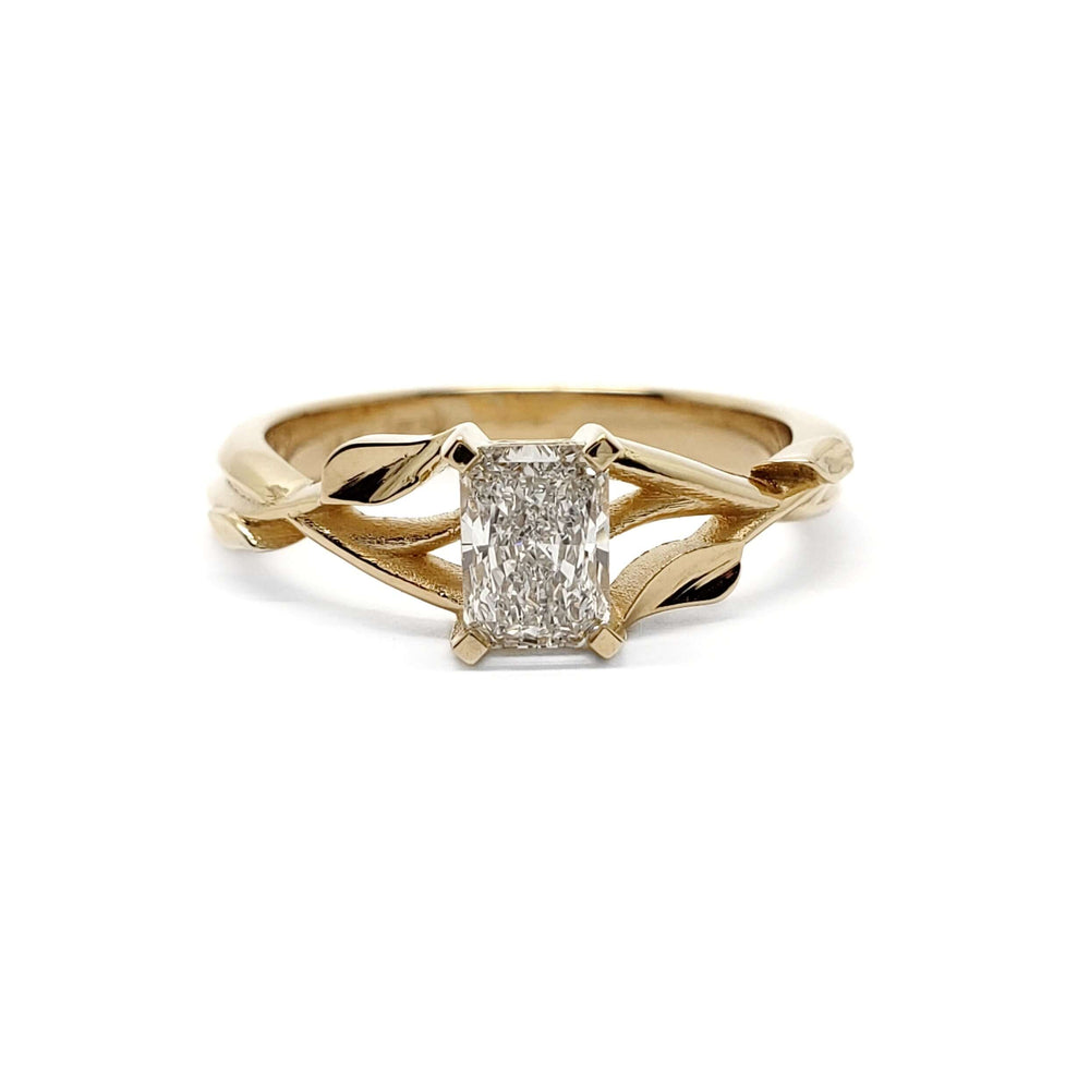 Front view of 14kt yellow gold engagement ring with radiant lab diamond and leaf design