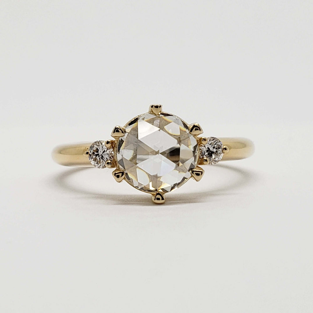 Front view of 14kt yellow gold engagement ring with rose cut lab diamond and side stones