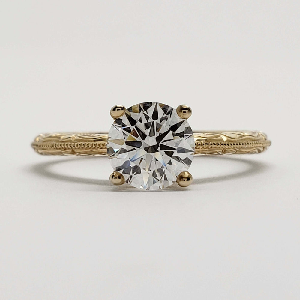 Front view of 14kt yellow gold engagement ring with round lab diamond and engraved details