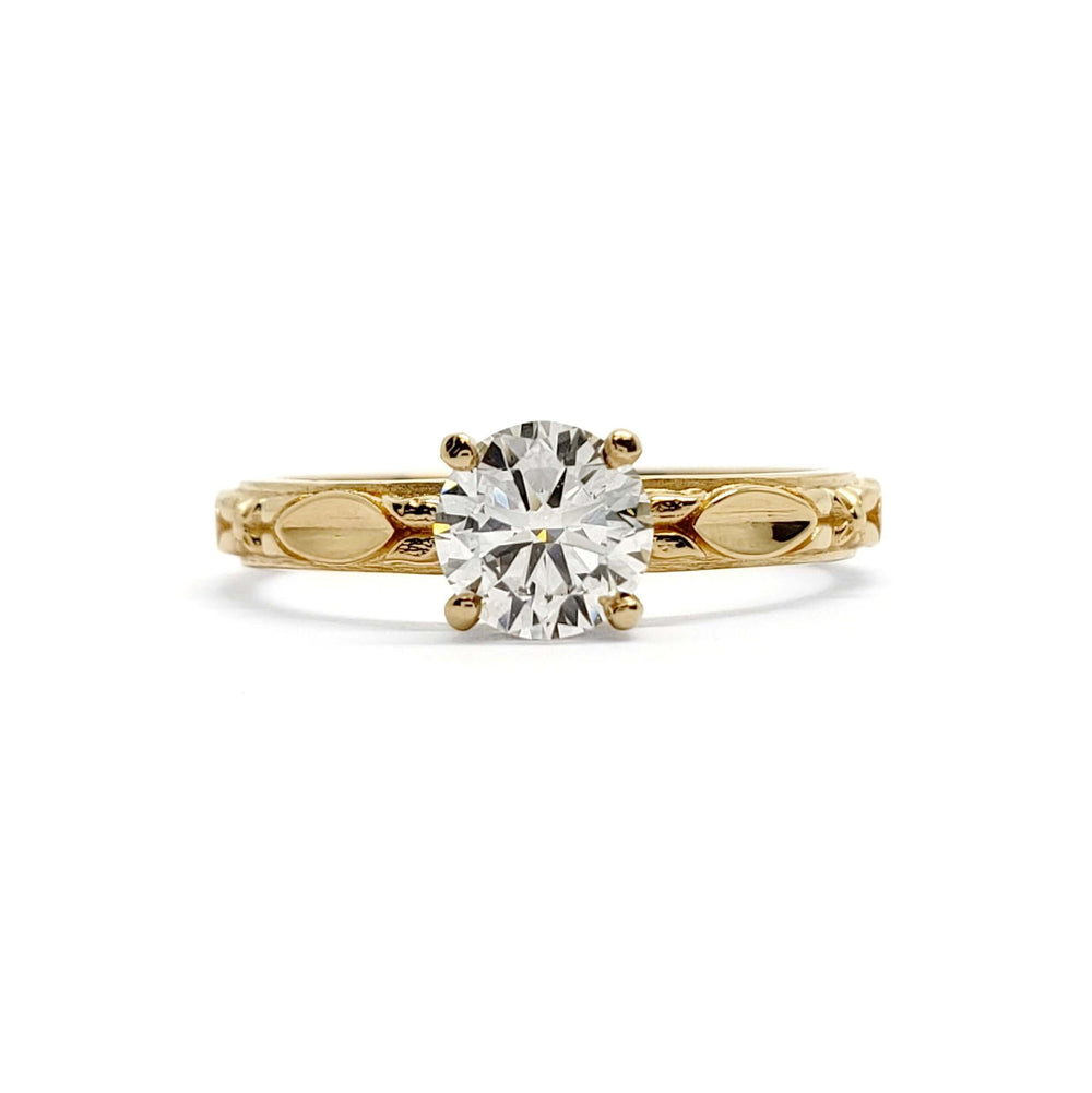 Front view of 14kt yellow gold engagement ring with round lab diamond and leaf motif