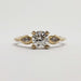 Front view of 14kt yellow gold engagement ring with round lab diamond and marquise side stones