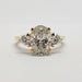 Front view of 14kt yellow gold ring with oval lab-grown diamond and two round lab diamonds