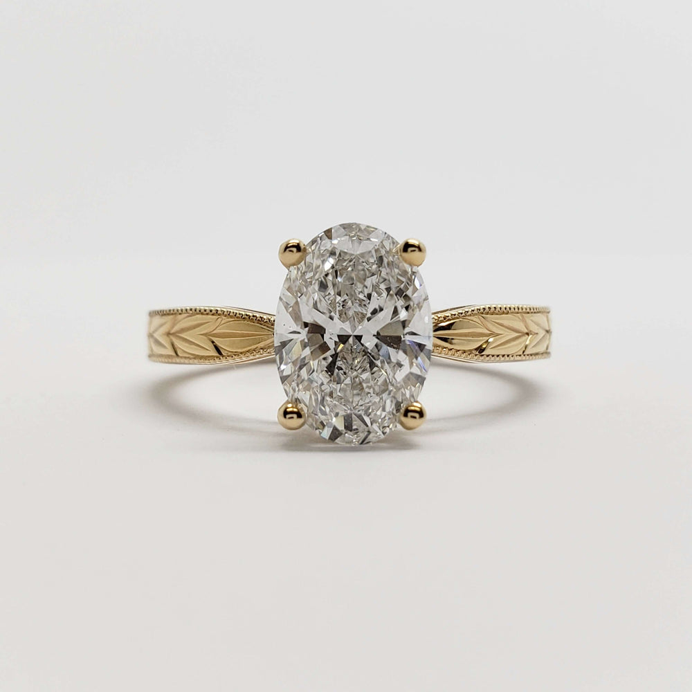 Front view of 14kt yellow gold oval lab diamond engagement ring with engraved details