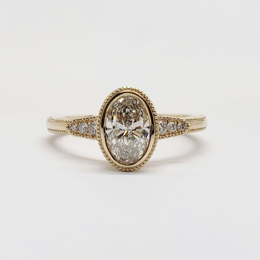 Front view of 14kt yellow gold oval lab diamond engagement ring with millgrain edges