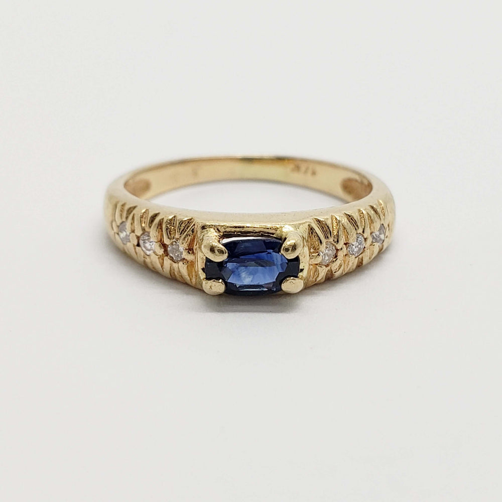 Front view of 14kt yellow gold pinky ring with blue sapphire and diamonds