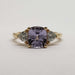 Front view of 14kt yellow gold ring with lavender sapphire and trillion lab diamonds