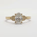 Front view of 14kt yellow gold ring with oval lab grown diamond and accent stones