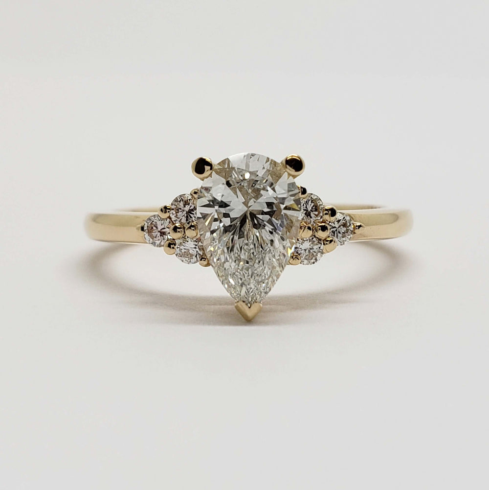 Front view of 14kt yellow gold ring with pear lab diamond and accent diamonds