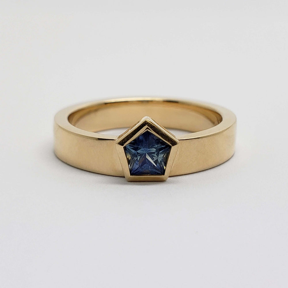 Front view of 14kt yellow gold ring with pentagon-cut blue sapphire