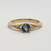 Front view of 14kt yellow gold ring with round teal Montana sapphire