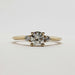 Front view of 14kt yellow gold three-stone diamond engagement ring with round center stone