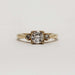 Front view of a 14kt yellow gold engagement ring with three vintage round diamonds