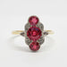 Front view of Art Deco 18kt gold ring with three red glass stones and diamond accents