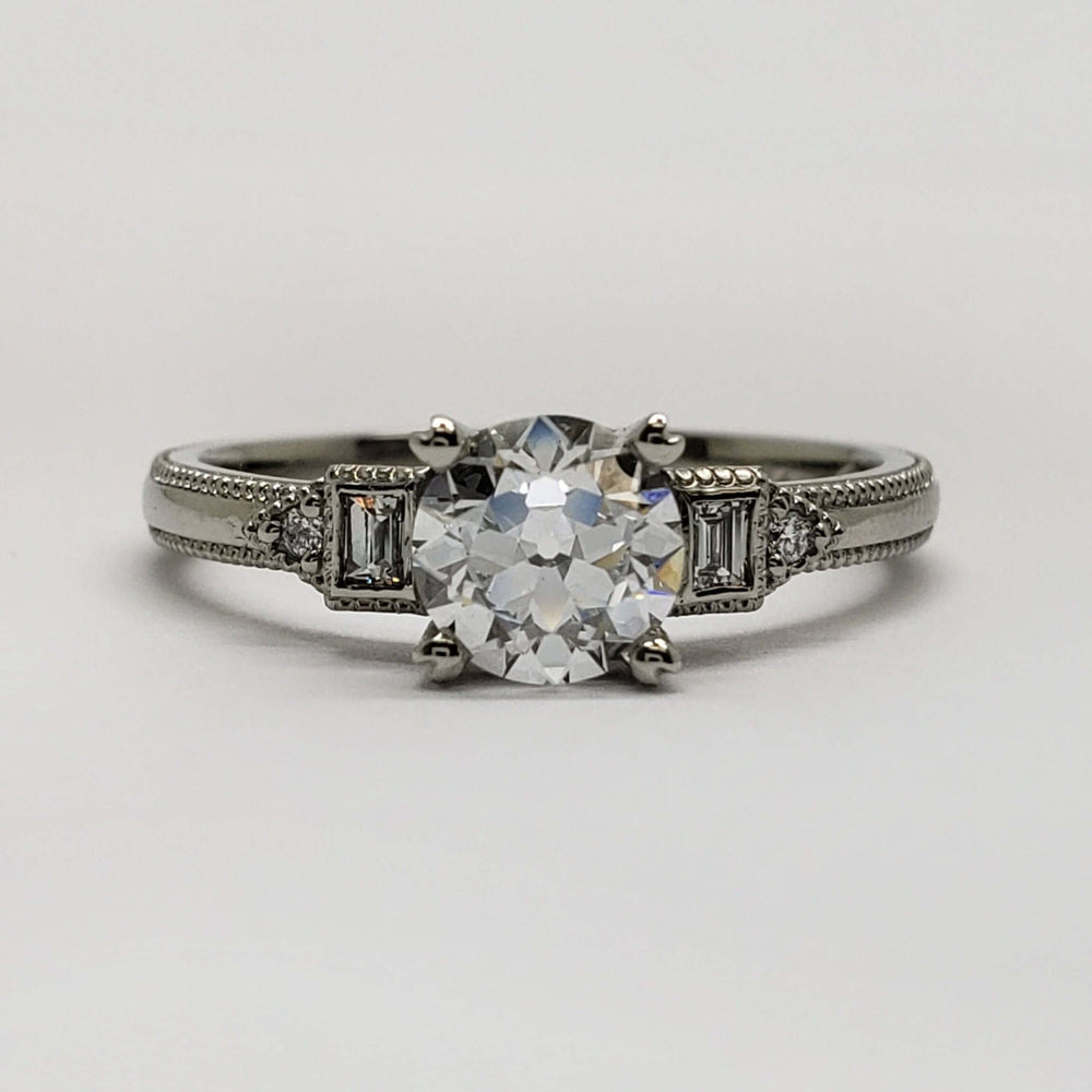 Front view of 14kt white gold engagement ring with European cut lab diamond and baguette side stones