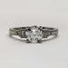Front view of 14kt white gold engagement ring with European cut lab diamond and baguette side stones