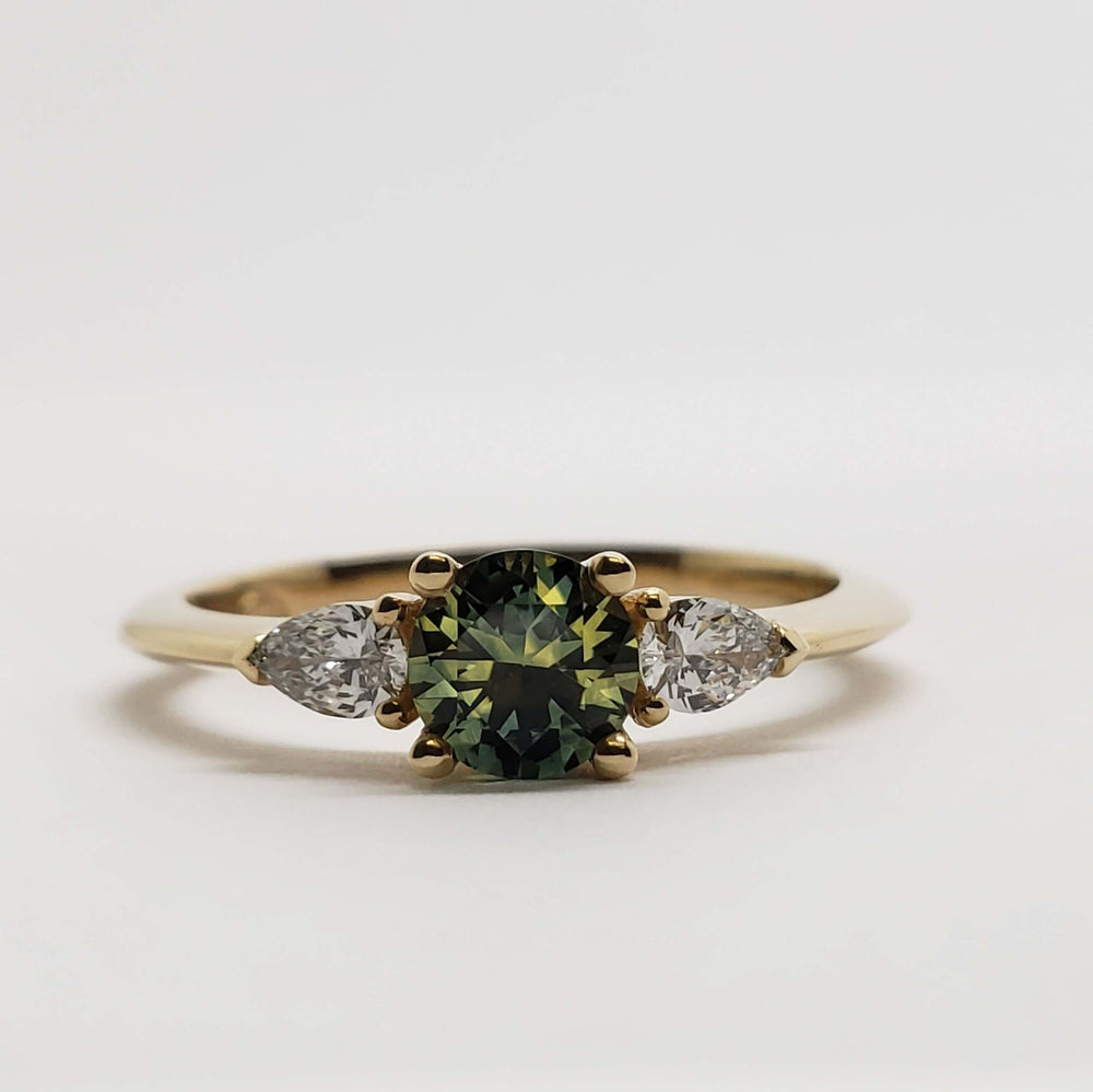 Front view of 14kt yellow gold ring with green-yellow Montana sapphire and lab diamonds