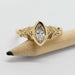 Front view of Oriana 14kt yellow gold ring with marquise lab diamond on a pencil